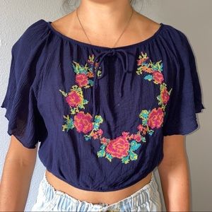 Slightly cropped, light, blue flower shirt